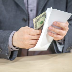 A young businessman working from his office and counting cash money